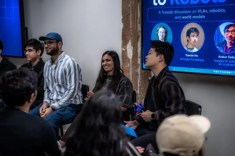 Four speakers in conversation during the From Tokens to Robots panel