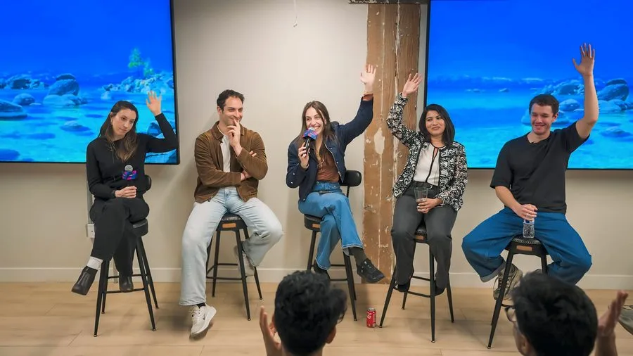 Five Agents and APIs speakers smiling and waving from the stage