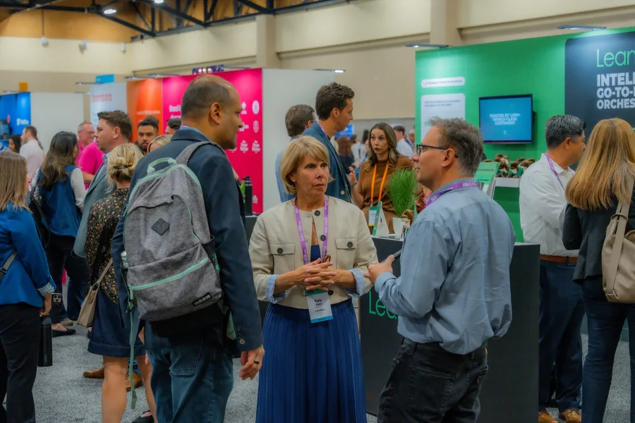 Attendees talking with the team at the LeanData booth