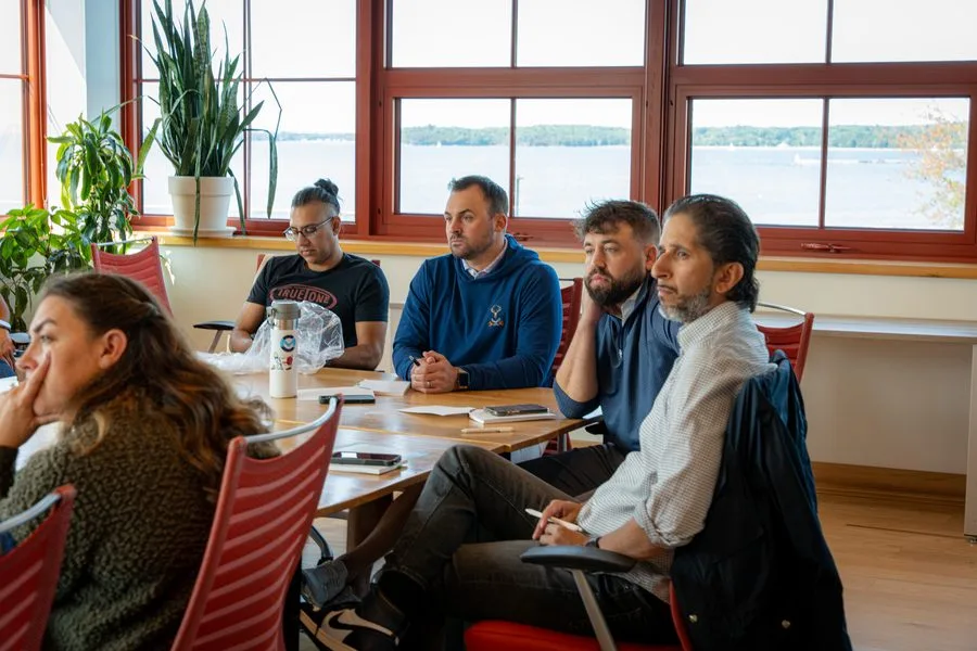 Attendees listening during a sunlit Drive 2025 workshop