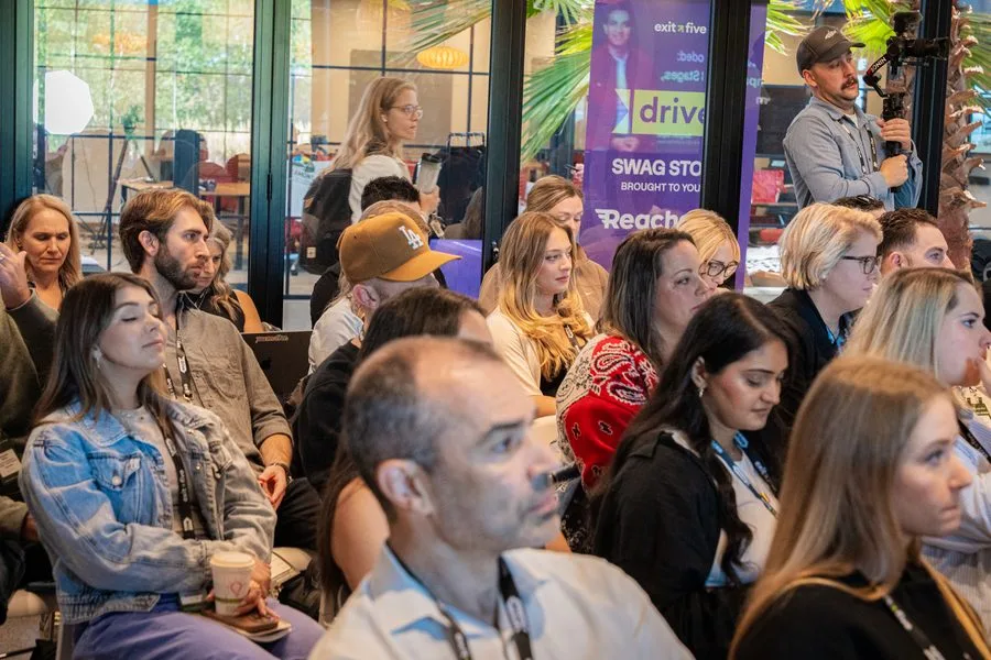 An engaged Drive 2025 audience beneath warm pendant lights