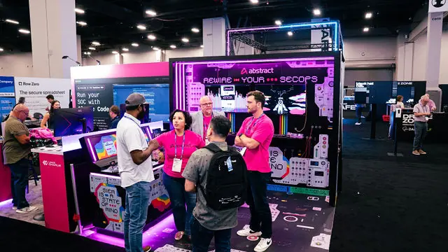 A wide view of the Abstract Security booth and team