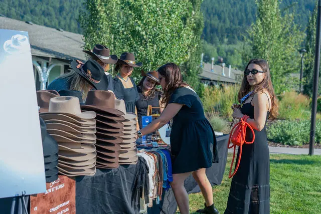 Guests choosing hats at an outdoor Highline activation