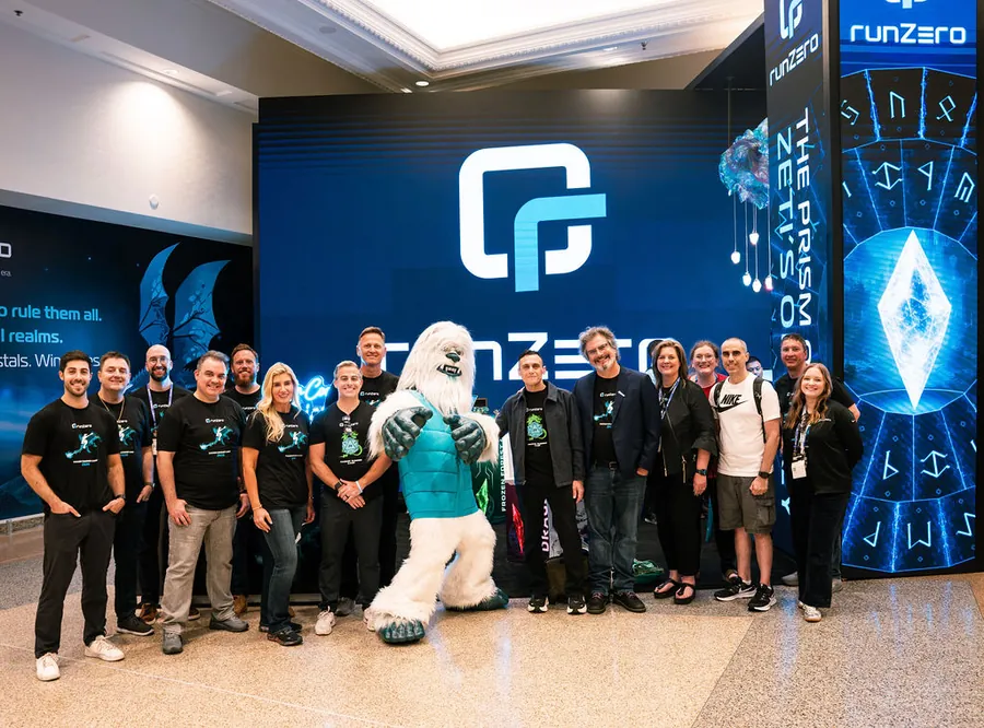 The runZero team and Zeti mascot at their Black Hat activation