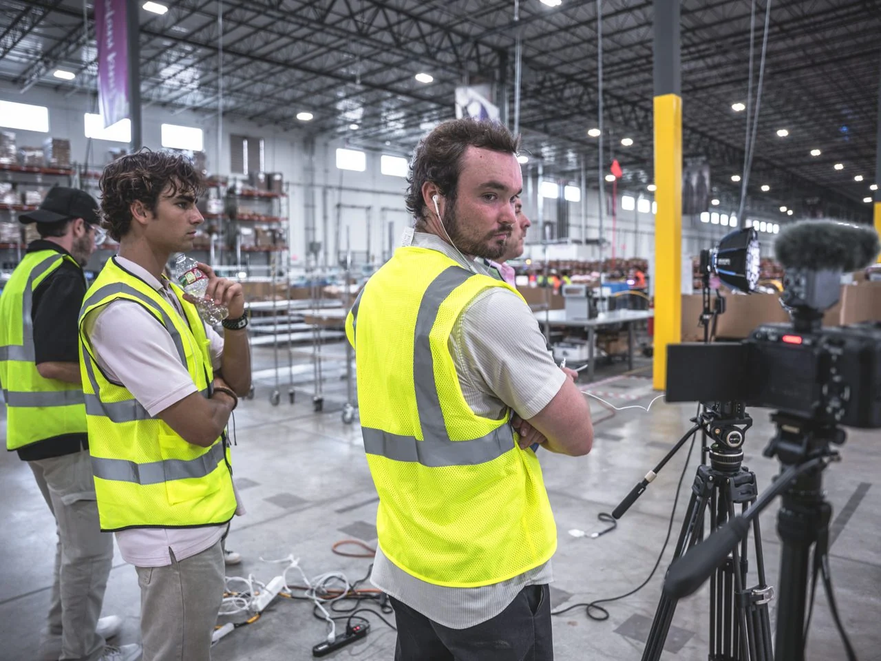 EventShark crew preparing a camera setup on a warehouse floor